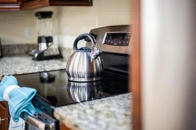 a tea kettle sitting on top of a stove at Encore Resort luxury house 8 bedrooms, pool and spa in Orlando