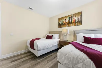 a bedroom with two beds and a painting on the wall at Encore Resort luxury house 8 bedrooms, pool and spa in Orlando