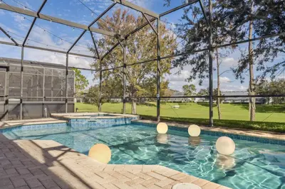 an indoor swimming pool with a large glass building at Arcade and Pool Villa, 4 km to Disney in Orlando