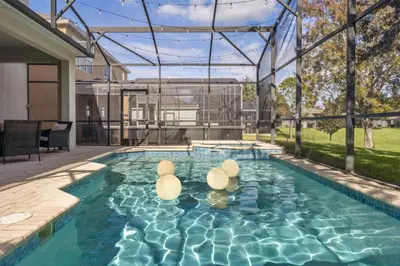a swimming pool in the backyard of a house at Arcade and Pool Villa, 4 km to Disney in Orlando