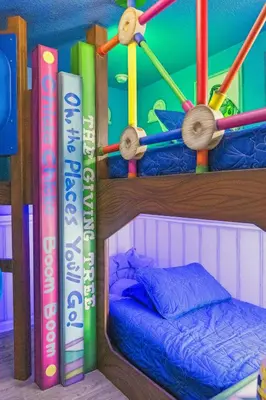 a room with two bunk beds with books at Arcade and Pool Villa, 4 km to Disney in Orlando