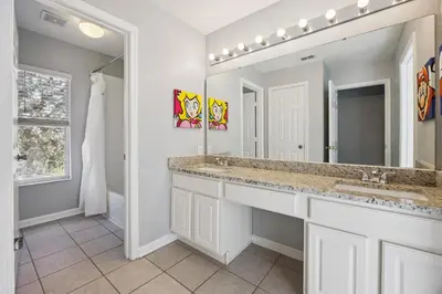 a bathroom with a sink and a mirror at Arcade and Pool Villa, 4 km to Disney in Orlando