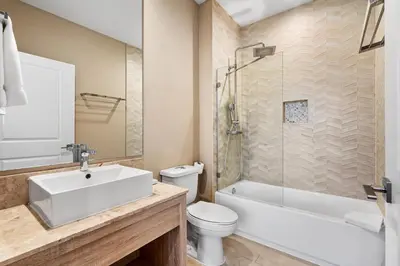 a bathroom with a sink and a toilet and a shower at Bright and Modern Townhome at Magic Village – Superb Disney Location in Orlando