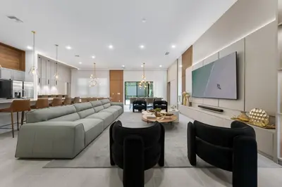 a living room with a couch and a tv at Brand New Modern State of the Art Home! Sleeps 31 in Kissimmee