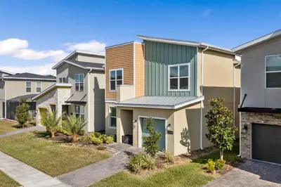 a row of houses in a residential neighborhood at 5BR/5BA Home & Storey Lake Water Park Amenities in Kissimmee
