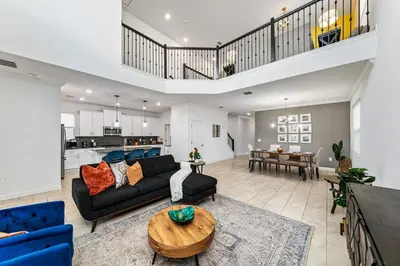 a living room with a couch and a table at 5BR/5BA Home & Storey Lake Water Park Amenities in Kissimmee