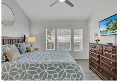 a bedroom with a bed and a flat screen tv at Windsor Hills Resort in Orlando