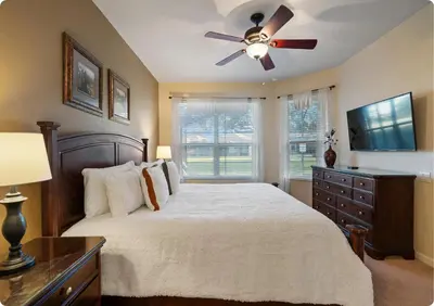 a bedroom with a bed and a ceiling fan at Windsor Hills Resort in Orlando