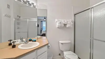 a bathroom with a toilet and a sink and a shower at Windsor Hills Resort in Orlando