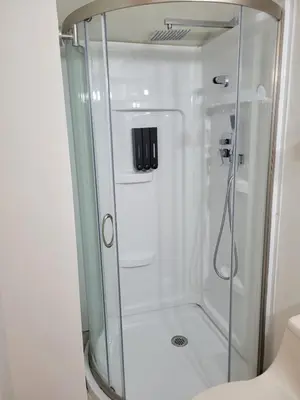 a shower with a glass door in a bathroom at A cozy stay with everything you need! in Kissimmee