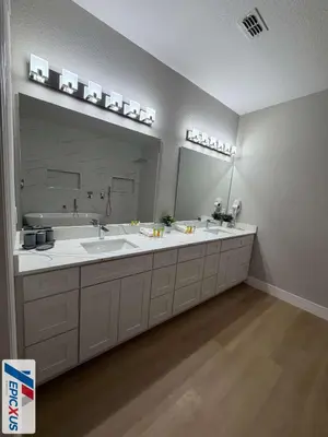 a bathroom with two sinks and a large mirror at The Epic 11 Vista Cay Resort Orlando Florida in Orlando