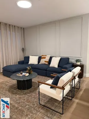 a living room with a blue couch and a table at The Epic 11 Vista Cay Resort Orlando Florida in Orlando