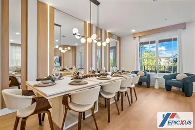 a dining room with a long table and chairs at The Epic 3 Lake View Vista Cay Resort Orlando Florida in Orlando