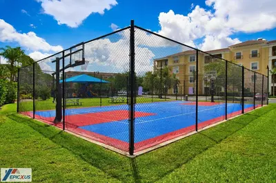 a tennis court with a net in a park at The Epic 3 Lake View Vista Cay Resort Orlando Florida in Orlando