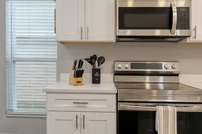 a kitchen with a stove and a microwave at Disney-Area 4BR | Pool + Patio in Kissimmee