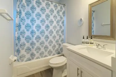 a bathroom with a sink and a toilet and a shower curtain at Disney-Area 4BR | Pool + Patio in Kissimmee