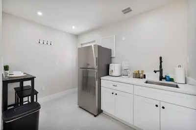 a kitchen with a stainless steel refrigerator and a sink at Pet Friendly Studio Unit Near Downtown and Parks - 20 mi to Disney in Saint Cloud