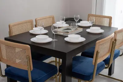 a black table with chairs and plates and wine glasses at Downtown Home with Basketball, Firepit and Just 20 Miles to Disney in Saint Cloud