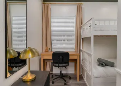 a bedroom with a desk and a bunk bed at 10 Minutes to Downtown with Jacuzzi, Pool Table, Ping Pong, and BBQ in Orlando