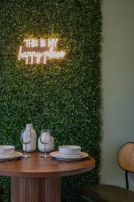 a table with wine glasses and a sign that says this is my happy place at Cozy Orlando Studio with Jacuzzi, Fire Pit, and BBQ in Orlando