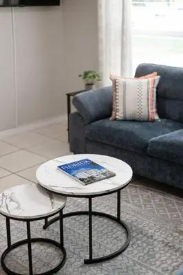a living room with a couch and a coffee table at Stylish 2BR Home Near Disney and Universal Orlando in Orlando