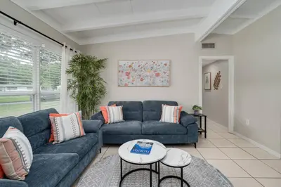 a living room with a couch and a table at Stylish 2BR Home Near Disney and Universal Orlando in Orlando