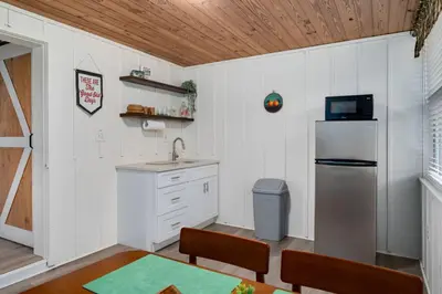 a small kitchen with a sink and a refrigerator at Modern Downtown Orlando Studio in a Prime Location in Orlando