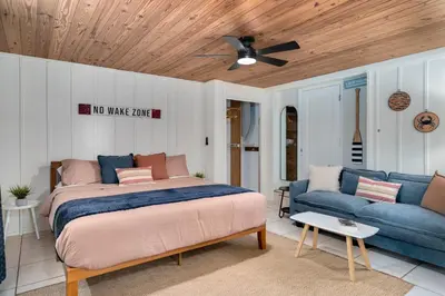 a bedroom with a bed and a couch at Hip Orlando Studio Nearby Restaurants and Parks in Orlando