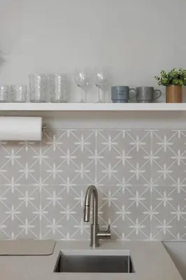 a kitchen with a sink and a shelf with wine glasses at Chic Studio Near Downtown & Theme Parks in Orlando