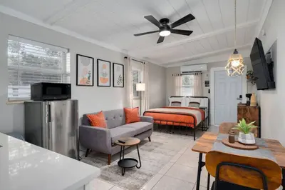 a living room with a couch and a bed at Chic Studio Near Downtown & Theme Parks in Orlando
