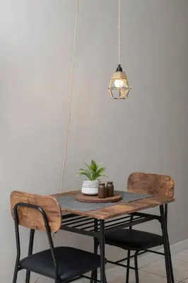 a wooden table with two chairs and a potted plant at Chic Studio Near Downtown & Theme Parks in Orlando