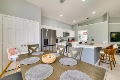 a kitchen and dining room with a table and chairs at Resort Perks! Family Home 4 Mi to Disney World in Kissimmee