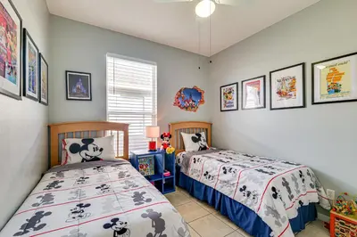 two beds in a childs bedroom with pictures on the walls at Resort Perks! Family Home 4 Mi to Disney World in Kissimmee