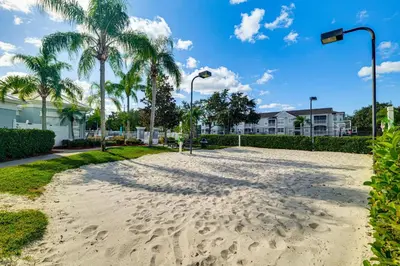 a sand road with palm trees and street lights at Resort Perks! Family Home 4 Mi to Disney World in Kissimmee