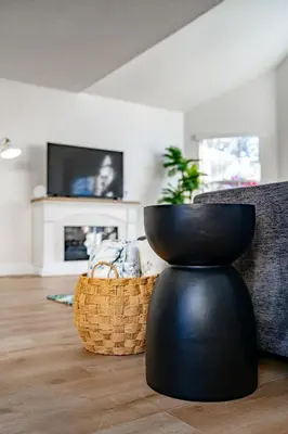 a living room with a black vase and a couch at Bright Ground Floor Condo Minutes to Parks in Kissimmee