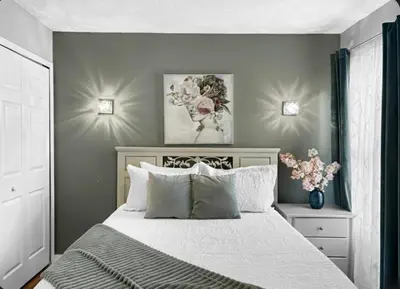 a bedroom with a large bed with white sheets and pillows at NEW Luxury 7BR Villa 4 Mi to Disney Pool & Spa in Kissimmee