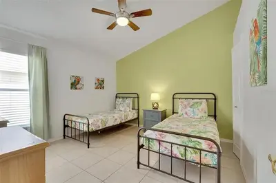 a bedroom with two beds and a ceiling fan at 5BR 4BA Near Disney, Pool, Sauna, Pets Allowed in Kissimmee