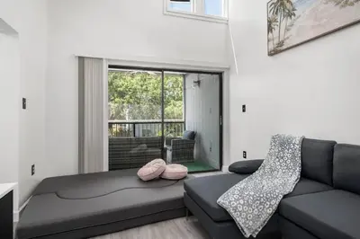 a living room with a couch and a window at Condo with Pool, Gym, Golf, Jacuzzi and Game Areas in Orlando