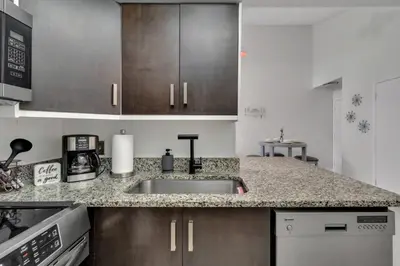a kitchen with a sink and a counter top at Cozy Golf Condo with 3 Pools, Gym and Just 15 Minutes to Airport in Orlando