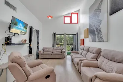 a living room with a couch and two couches at Cozy Golf Condo with 3 Pools, Gym and Just 15 Minutes to Airport in Orlando