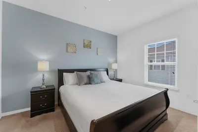 a bedroom with a large bed and a window at 8925 Resort 4BR Townhouse by Disney World Orlando in Kissimmee