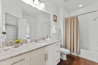 a white bathroom with a sink and a toilet at 8925 Resort 4BR Townhouse by Disney World Orlando in Kissimmee