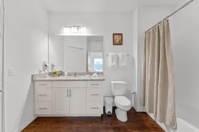 a white bathroom with a toilet and a sink at 8925 Resort 4BR Townhouse by Disney World Orlando in Kissimmee