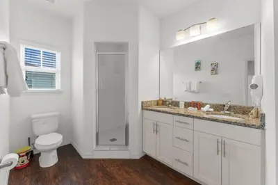 a bathroom with a toilet and a sink and a shower at 8925 Resort 4BR Townhouse by Disney World Orlando in Kissimmee
