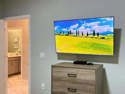 a flat screen tv sitting on top of a dresser at 4263PD-New Listing- 5 bed/4 bath-Private Pool in Kissimmee