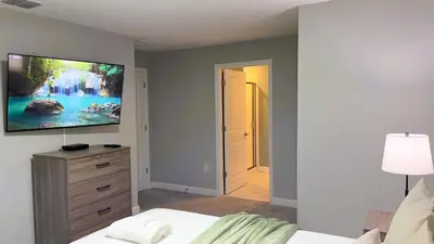 a bedroom with a bed and a tv on a wall at 4263PD-New Listing- 5 bed/4 bath-Private Pool in Kissimmee
