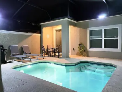 a swimming pool with chairs and a table in a house at 4263PD-New Listing- 5 bed/4 bath-Private Pool in Kissimmee