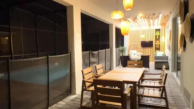 a dining room with a wooden table and chairs at 4573TB-New Listing- 10bed/5 bath-Private Pool in Kissimmee
