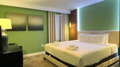 a bedroom with a bed with two towels on it at 4573TB-New Listing- 10bed/5 bath-Private Pool in Kissimmee