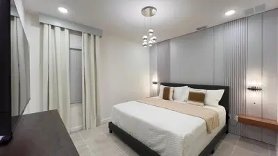 a bedroom with a bed with white sheets and pillows at 6277SK-New Brand-12bed/11.5bath-Private Pool&SPA in Orlando